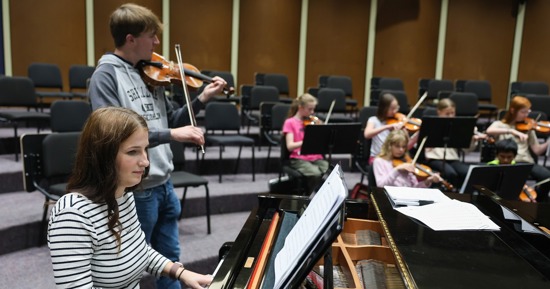 UNK students Abbygail Marshall and Noah Reimer lead a UNK String Project class in the Fine Arts Building on campus. The program provides high-quality, low-cost music instruction for Kearney-area youths. (Photo by Erika Pritchard, UNK Communications)